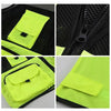 Close-up view of a neon yellow high-visibility safety vest featuring black mesh fabric and reflective pockets.