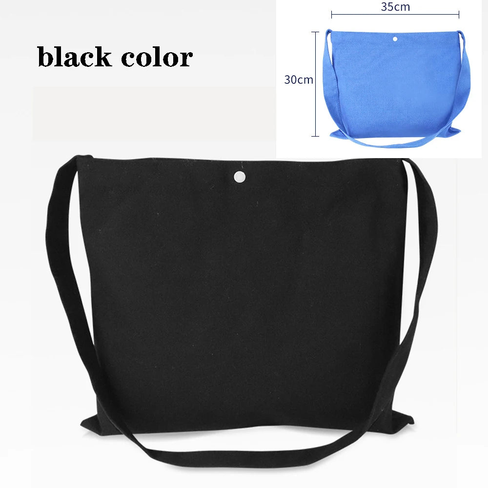 Black canvas tote bag with black straps and a silver button, shown next to a blue version.