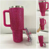 A magenta rhinestone tumbler with a straw and handle is shown in various angles.