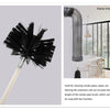 A black flexible chimney and dryer vent cleaning brush with a long extension rod shown next to a modern interior.