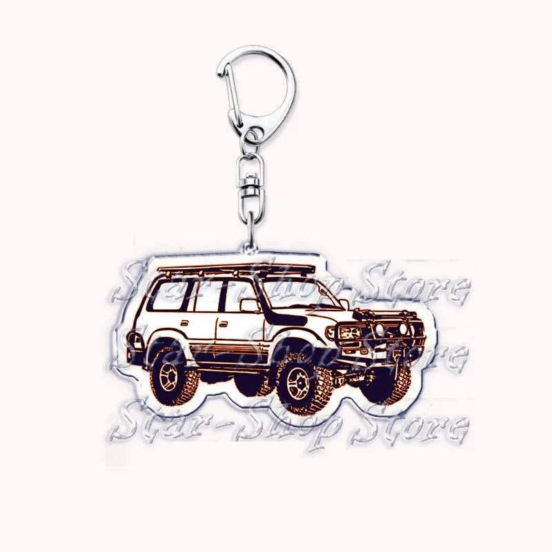 A silver metal key ring featuring a detailed illustration of an off-road truck.