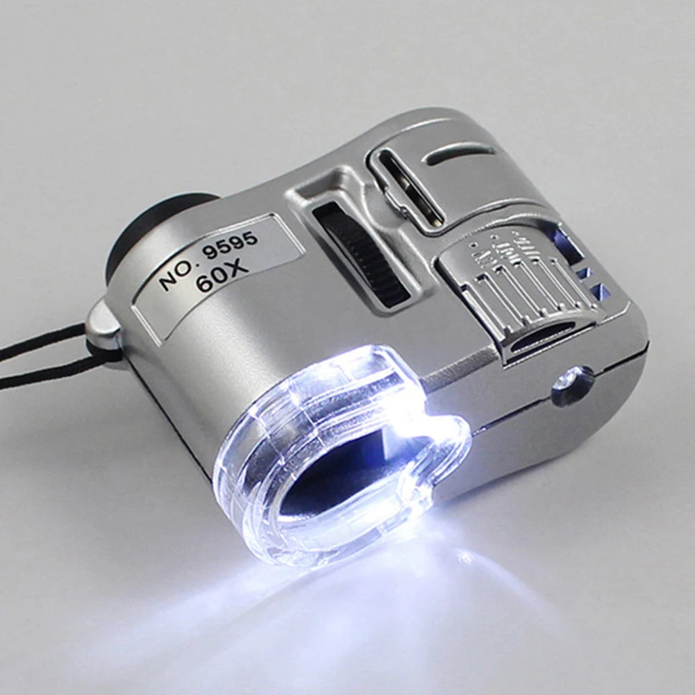 Silver handheld magnifier with a UV light and storage pouch, showing a bright beam of light.