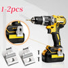 A yellow and black cordless drill with stainless steel belt clip hooks shown alongside spare clips.