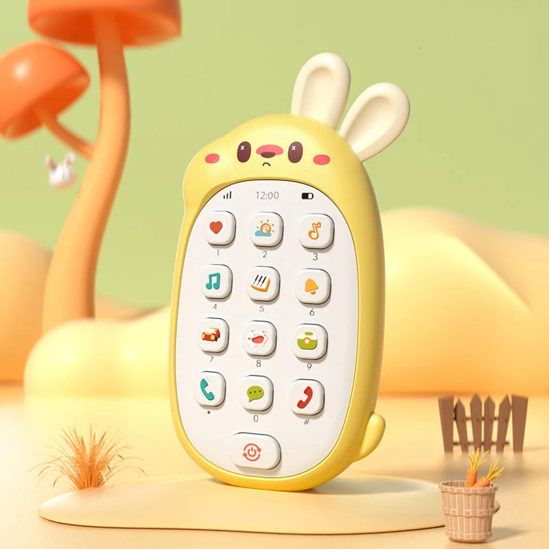 A yellow rabbit-shaped baby music phone toy with a teether resting on a light surface.