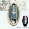 A close-up view of a gold-colored soft TPU car key fob cover with five buttons, shown next to the original black key.