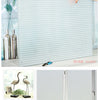 Frosted privacy window film with a vertical stripe pattern installed on a window.