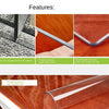 Close-up of a clear PVC waterproof table protector with a rounded edge resting on a wooden surface.