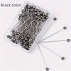 A clear plastic container filled with 100 black precision quilting pins for sewing and crafting.