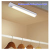 A white rechargeable motion sensor light bar mounted on a ceiling, with wooden hangers visible below.