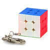 A colorful speed cube puzzle with blue and red faces, next to a silver key.