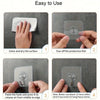 Demonstration of how to use clear heavy-duty self-adhesive wall hooks by cleaning the surface, tearing off the film, and appl