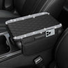 A black diamond quilted car armrest cover with storage is shown inside a vehicle interior.
