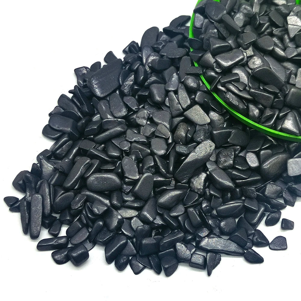 A pile of black tumbled crystal stone chips for healing, meditation, and decor.