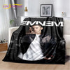 A black throw blanket featuring a portrait of Eminem and 2Pac hip-hop icons.