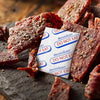 Dried meat pieces coated with spices and a warning label against eating them