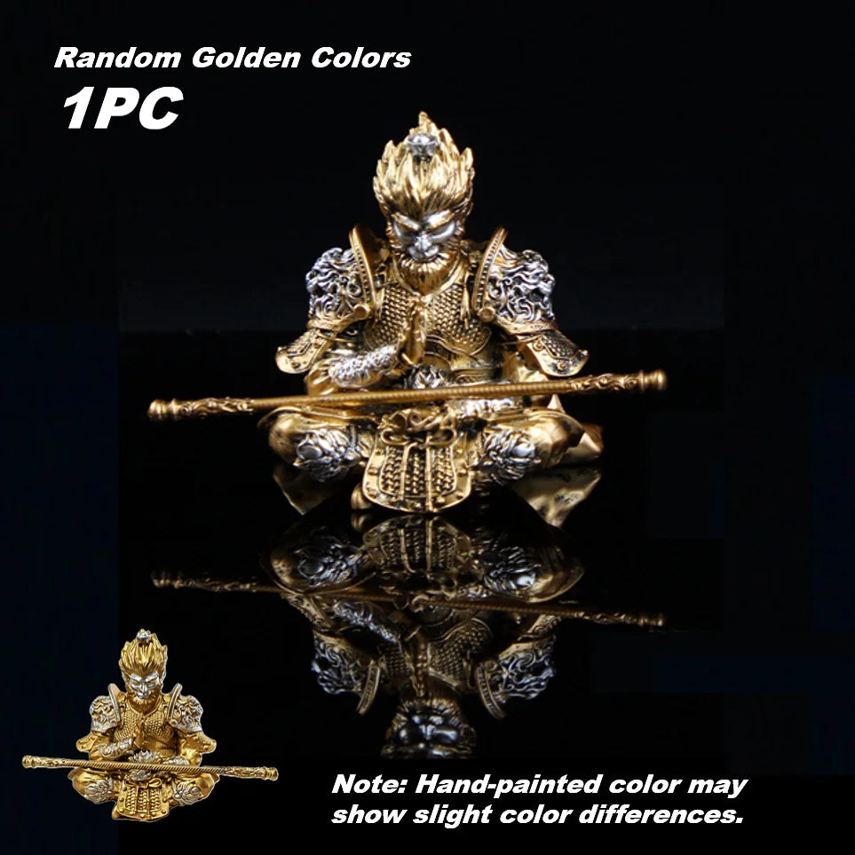 Hand-painted golden Monkey King figurine seated with a staff, shown against a dark background.