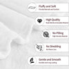 A close-up of a white knit throw blanket showing features like fluffiness, high quality stitching, and durability.