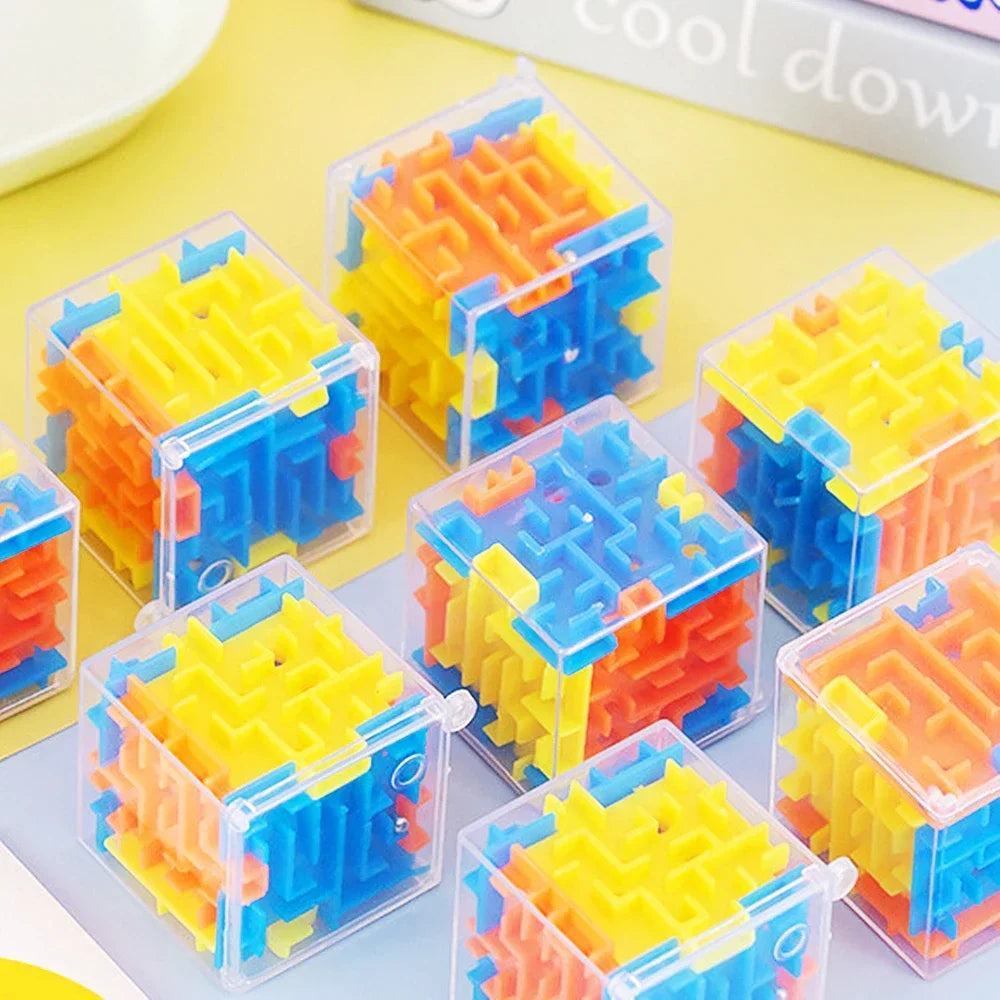 A collection of colorful, transparent 3D maze cubes made of plastic, arranged on a light surface.