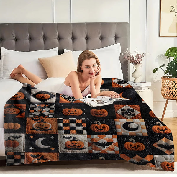 A woman relaxing on a bed covered with a vintage patchwork Halloween throw blanket featuring pumpkin and moon prints.