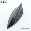 A black carbon fiber shark fin car antenna with a piano paint finish.