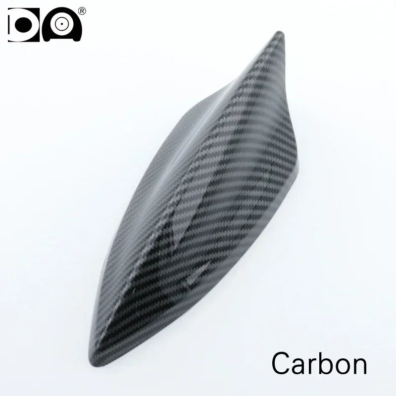 A black carbon fiber shark fin car antenna with a piano paint finish.