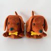 A pair of brown plush dachshund dog house slippers with yellow accents.