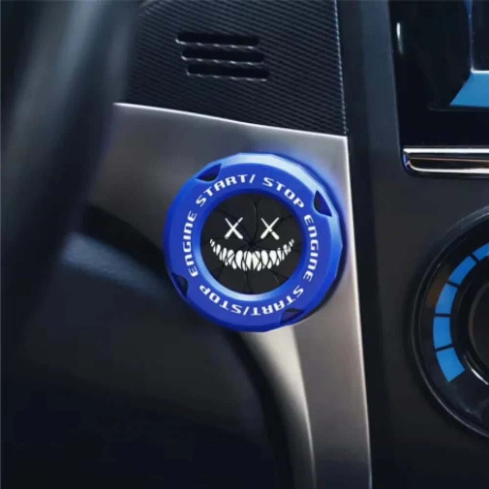 Close-up of a blue rotating protective cover for a car ignition start button with crossed teeth symbols.