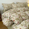 A set of soft printed duvet covers and pillowcases in a beige and terracotta floral pattern.