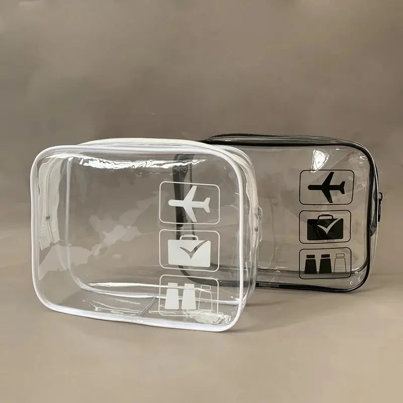 A clear plastic toiletry bag with black icons for travel organization is shown on a neutral background.