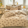 A beige duvet cover set featuring a cute dog print pattern with matching pillowcases and a small stuffed dog toy.