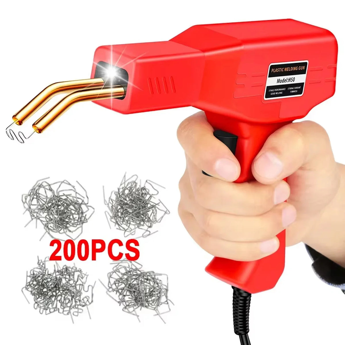 A hand holds a red plastic welding gun with a gold tip, next to several packs of metal wire.