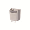 A light gray foldable hanging trash bin designed for kitchen and home use.
