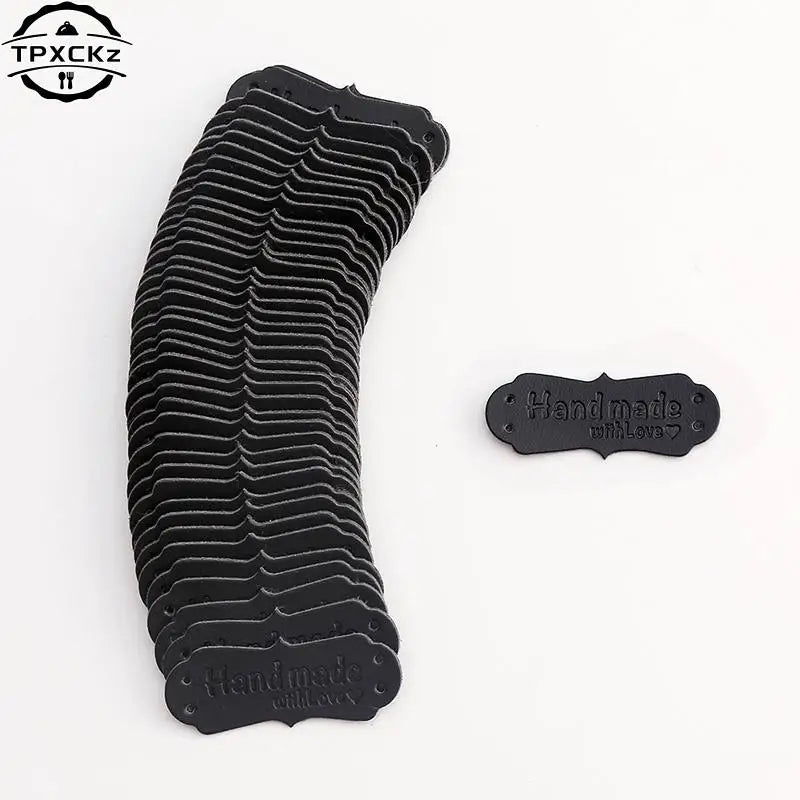 A stack of black PU leather sewing labels with a textured pattern for handmade crafts.