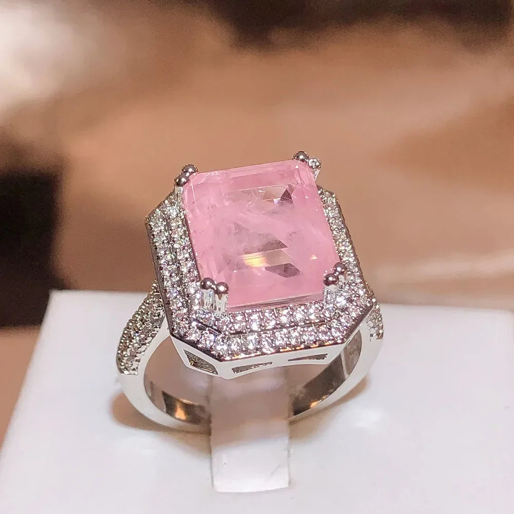 A pink Paraiba-style zircon cocktail ring set in sterling silver with a pave-set stone and geometric design.