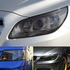Close-up of a car's headlight and taillight showing smoke black tint film application.