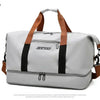 A grey and white travel duffle bag with brown straps and a silver zipper.