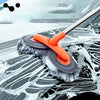 An orange extendable car wash mop with a dual chenille brush head cleaning water spots on a dark car surface.