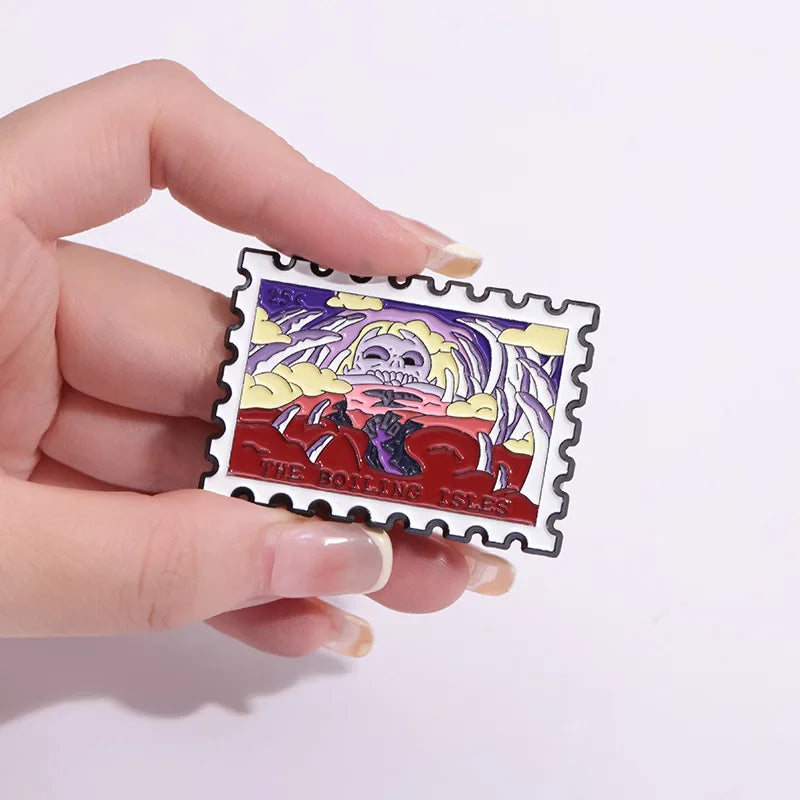A hand holds a vintage airline ticket enamel brooch featuring a stylized monster design.