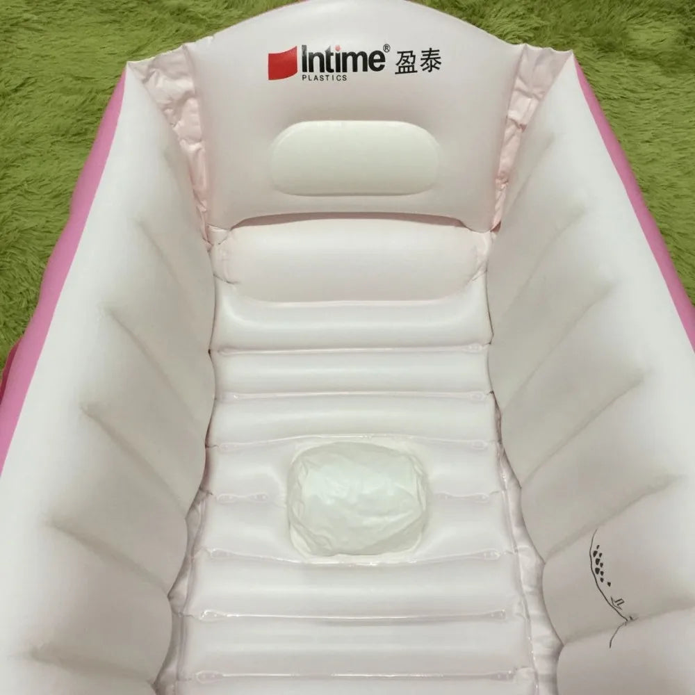 A white inflatable bathtub for babies and toddlers is shown, featuring a hand pump and pink accents.