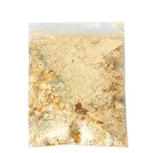 A sheet of metallic gold foil flakes for crafting, nail art, and resin projects.