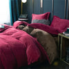 A deep red velvet duvet cover with a zipper and brown accents is displayed on a bed.
