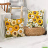 A yellow and white floral cushion cover featuring sunflowers and daisies on a woven straw cushion.