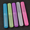 A row of six translucent silicone travel toothbrush cases in various colors including blue, green, purple, white, and pink.
