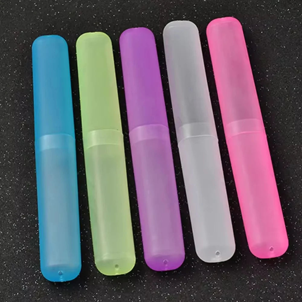 A row of six translucent silicone travel toothbrush cases in various colors including blue, green, purple, white, and pink.