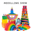 A colourful wooden rainbow stacking block set featuring various colored blocks and arches for creative building.