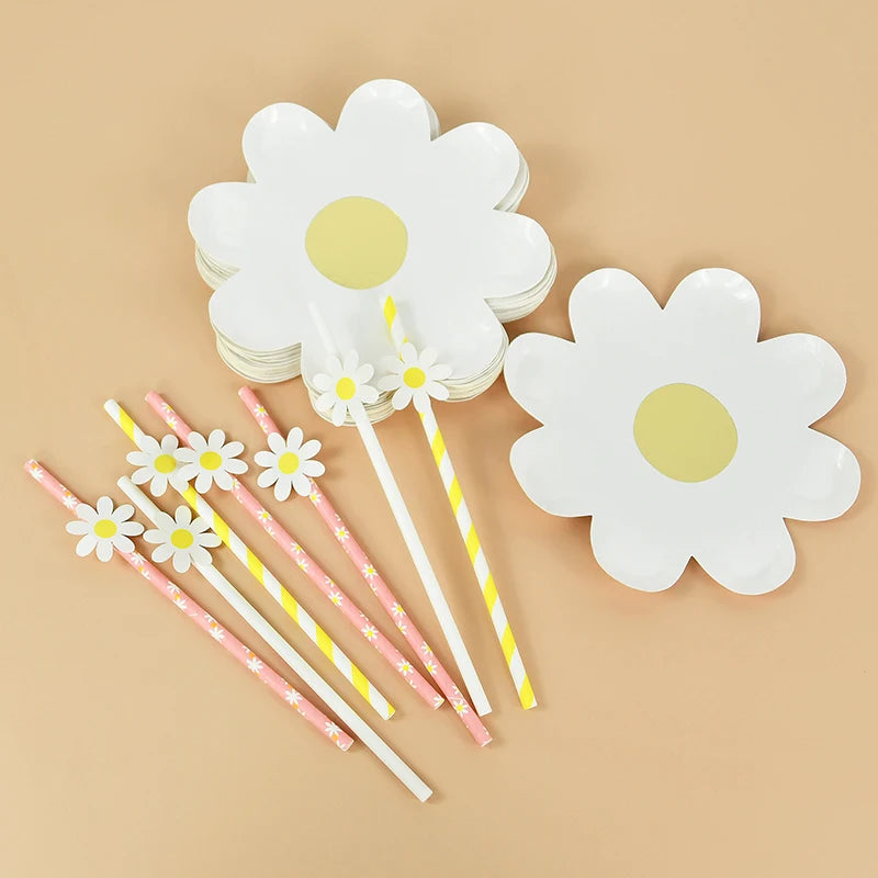 A set of white daisy flower disposable party tableware, including plates and striped wooden sticks.
