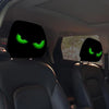 A pair of car headrest covers featuring glowing green eyes are visible in a vehicle interior.