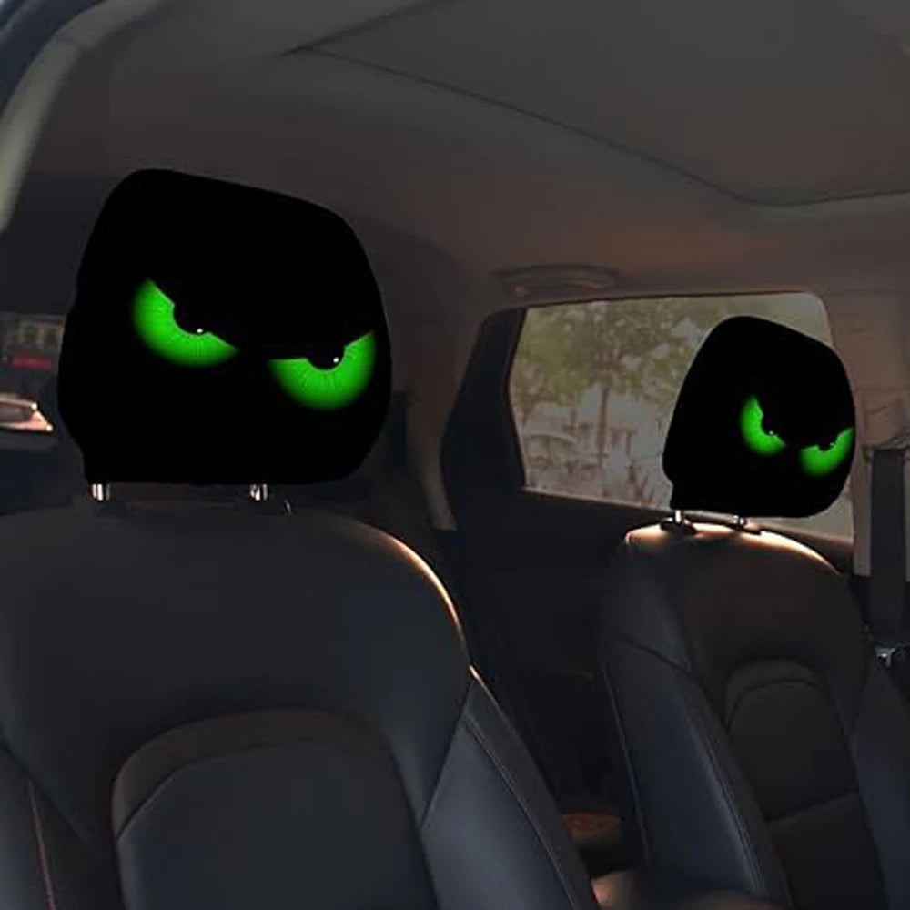 A pair of car headrest covers featuring glowing green eyes are visible in a vehicle interior.
