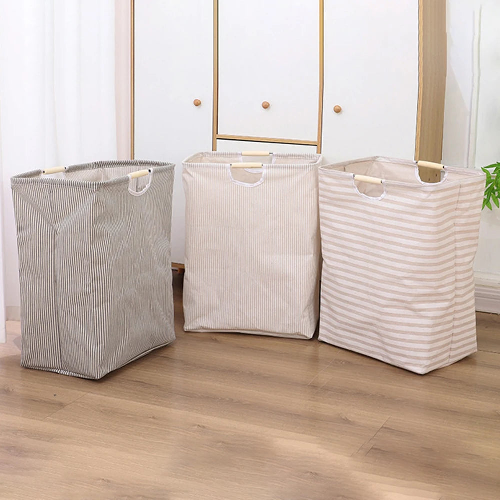 Two beige and gray striped laundry baskets with handles standing in front of a white mirror.