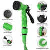 A green expandable magic hose with a multi-function nozzle, non-slip handle, and hose connector.